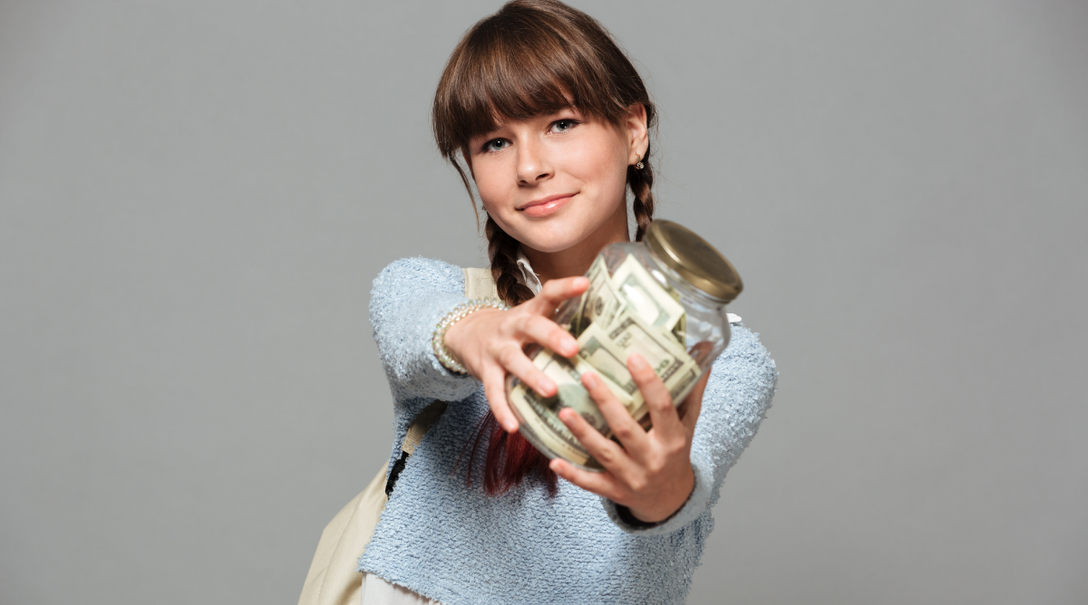  Adolescente sonriente sosteniendo un frasco con billetes, mostrando un claro gesto de ahorro. La imagen transmite la idea de la educación financiera desde temprana edad, donde la joven practica el hábito de ahorrar dinero, simbolizando responsabilidad financiera y hábitos saludables de ahorro.